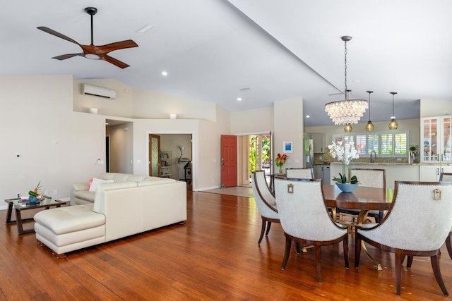 dining room featuring wood-type flooring, ceiling fan with notable chandelier, a wall mounted air conditioner, and high vaulted ceiling