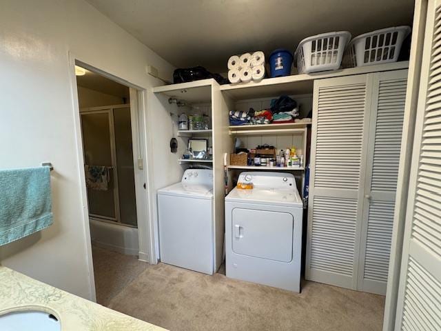 laundry area featuring light carpet, sink, and separate washer and dryer