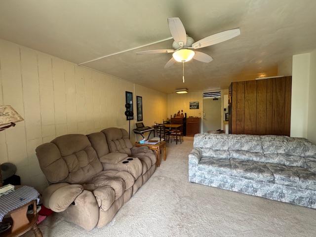 carpeted living room featuring ceiling fan