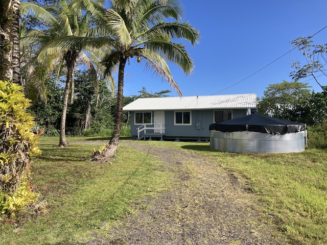 back of property featuring a lawn