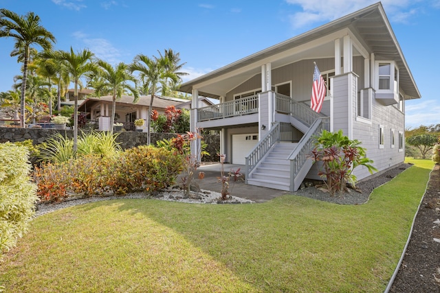 view of front of home featuring a balcony, a garage, and a front lawn