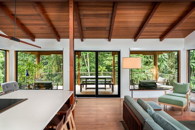 sunroom with vaulted ceiling with beams and wooden ceiling