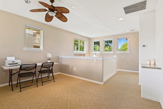 kitchen featuring ceiling fan and light colored carpet