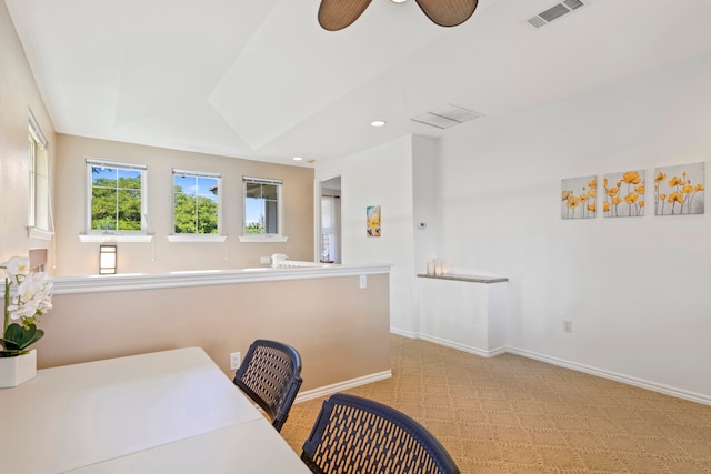 interior space featuring light colored carpet and ceiling fan