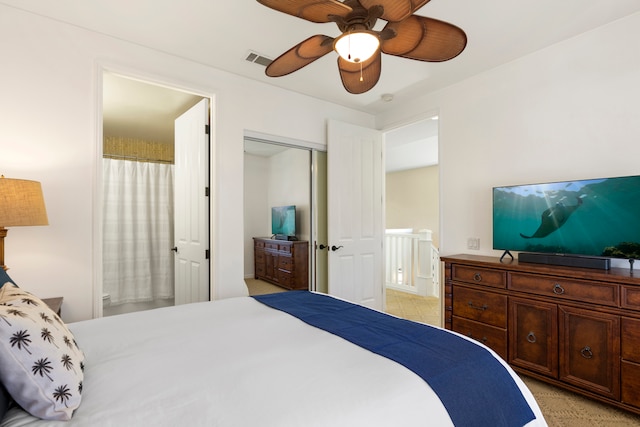 bedroom with a closet, ceiling fan, and ensuite bathroom