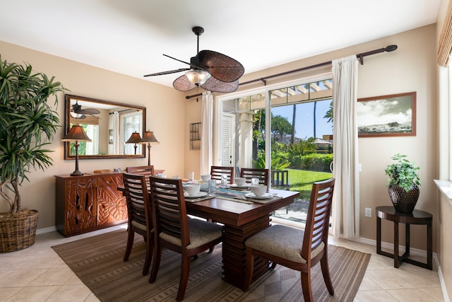 tiled dining space featuring ceiling fan