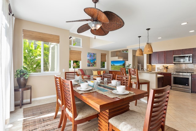 dining area with light tile patterned floors and ceiling fan