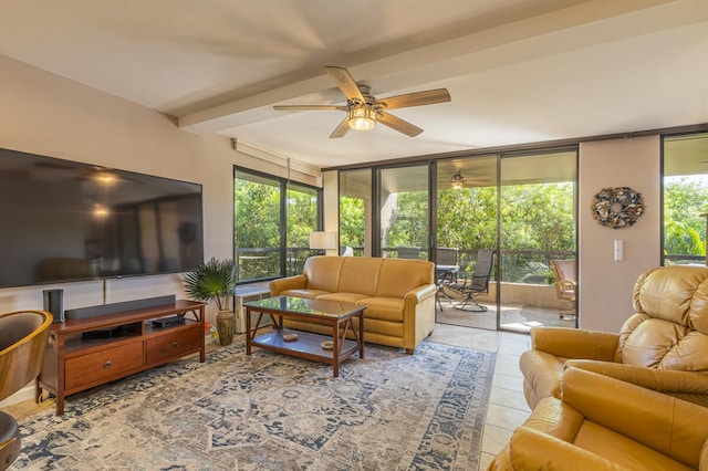 tiled living room featuring beam ceiling, plenty of natural light, ceiling fan, and a wall of windows