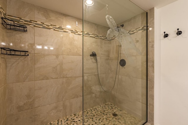 bathroom with a tile shower