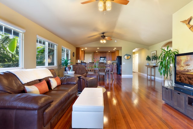 living room with ceiling fan, lofted ceiling, and dark hardwood / wood-style flooring