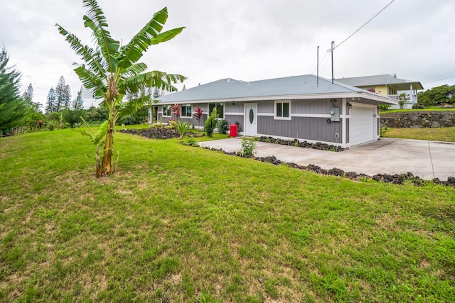 ranch-style home with an attached garage, concrete driveway, and a front yard