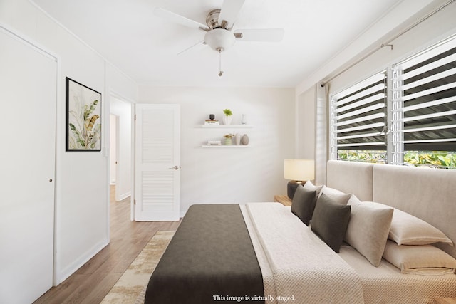 bedroom with ceiling fan and light hardwood / wood-style flooring