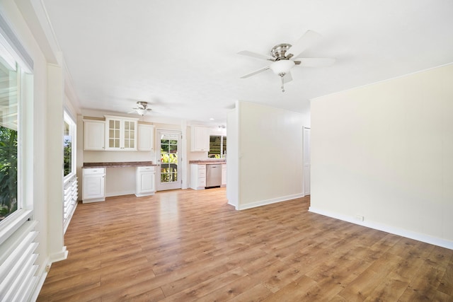 unfurnished living room featuring ornamental molding, ceiling fan, and light hardwood / wood-style flooring