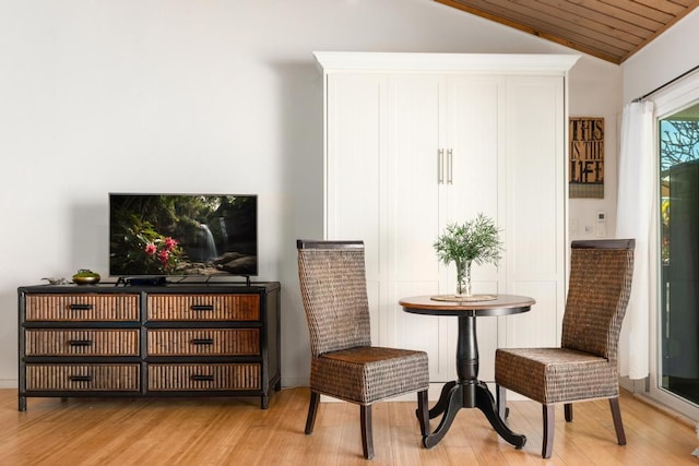 sitting room featuring lofted ceiling and light hardwood / wood-style floors