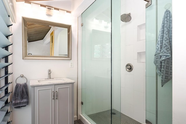 bathroom with vanity and a shower with shower door