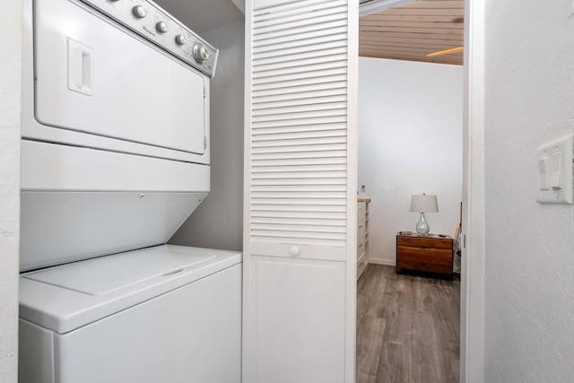 washroom with stacked washer and clothes dryer and light hardwood / wood-style floors