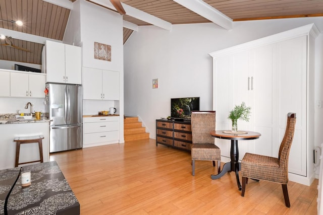 interior space featuring sink, high vaulted ceiling, wooden ceiling, beam ceiling, and light hardwood / wood-style floors