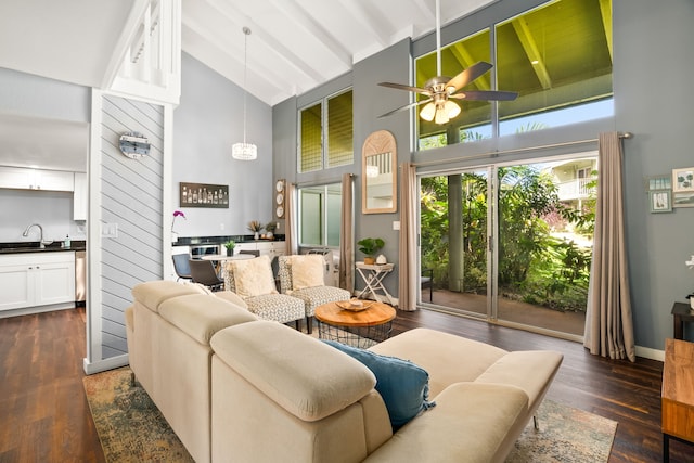 living room featuring beamed ceiling, high vaulted ceiling, a ceiling fan, baseboards, and dark wood-style flooring