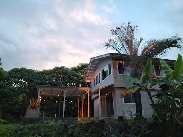 view of back house at dusk