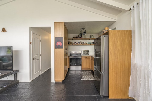 kitchen featuring vaulted ceiling and appliances with stainless steel finishes