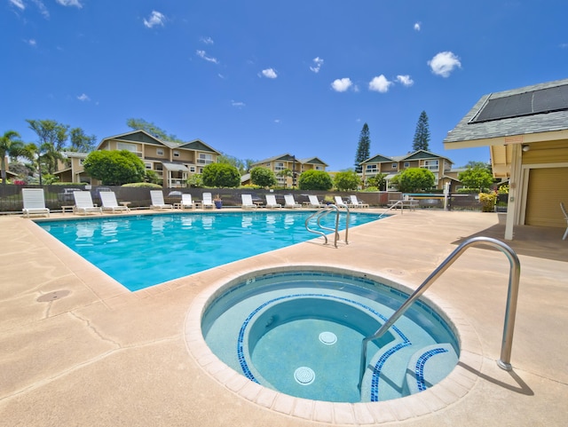 view of swimming pool with a community hot tub and a patio