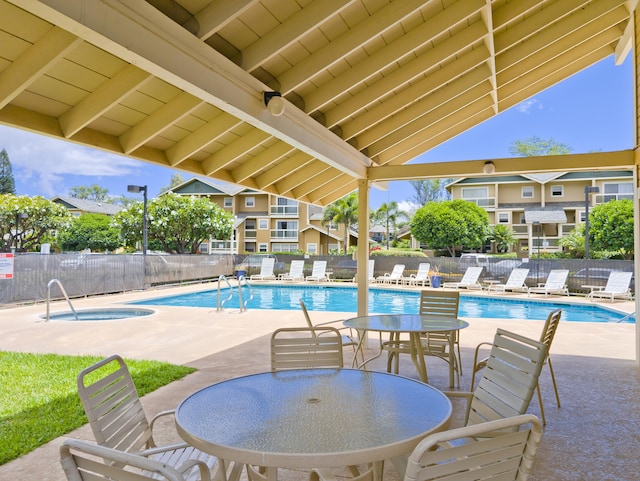 view of pool featuring a hot tub and a patio area