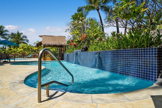 view of swimming pool with a gazebo, pool water feature, and a patio area