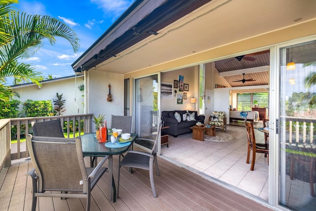 wooden terrace featuring ceiling fan and an outdoor hangout area