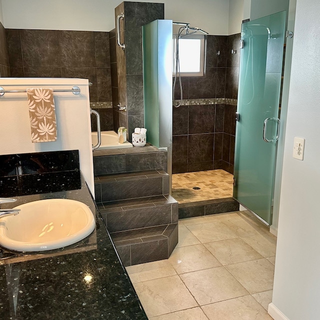 bathroom featuring tile patterned flooring, vanity, and separate shower and tub