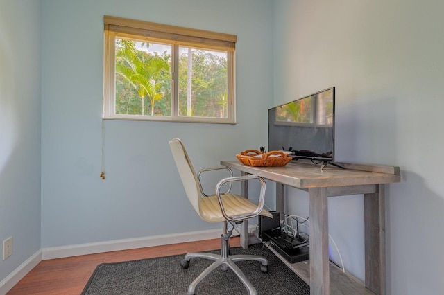 office space with wood-type flooring