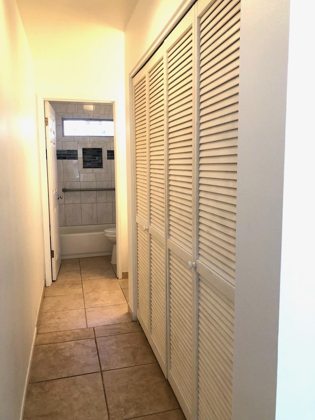 hallway with light tile patterned floors