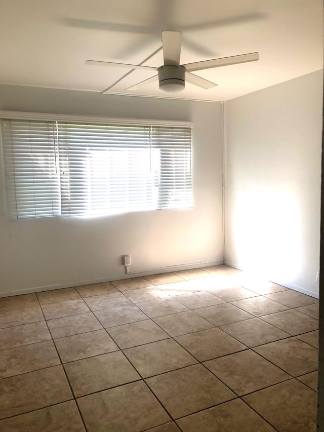 empty room with light tile patterned flooring and ceiling fan