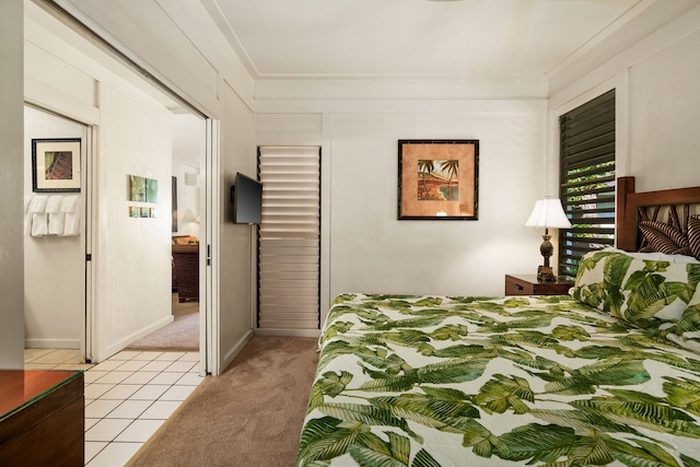 bedroom with light tile patterned flooring and ornamental molding