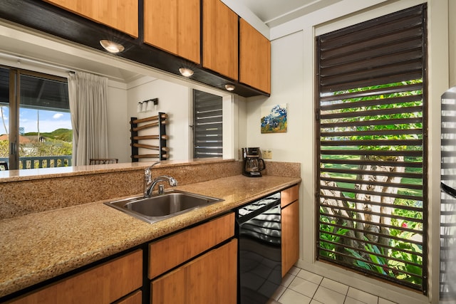 kitchen featuring sink, light tile patterned floors, light stone countertops, and black dishwasher