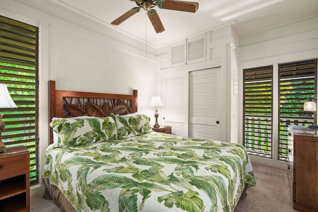 bedroom featuring multiple windows, a closet, ceiling fan, and carpet flooring