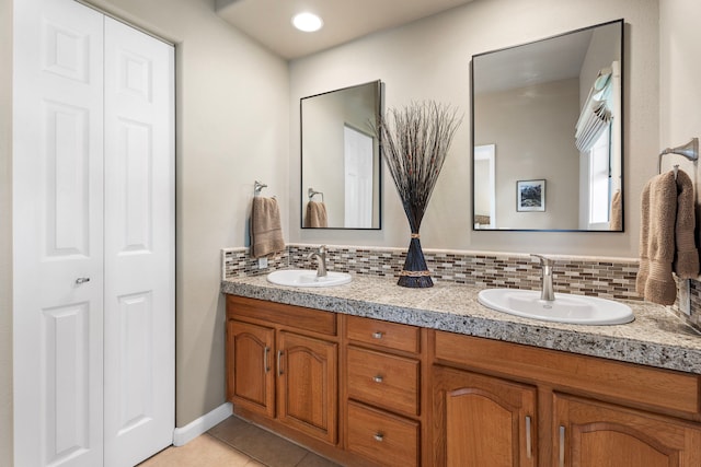 bathroom featuring vanity, tasteful backsplash, and tile patterned floors