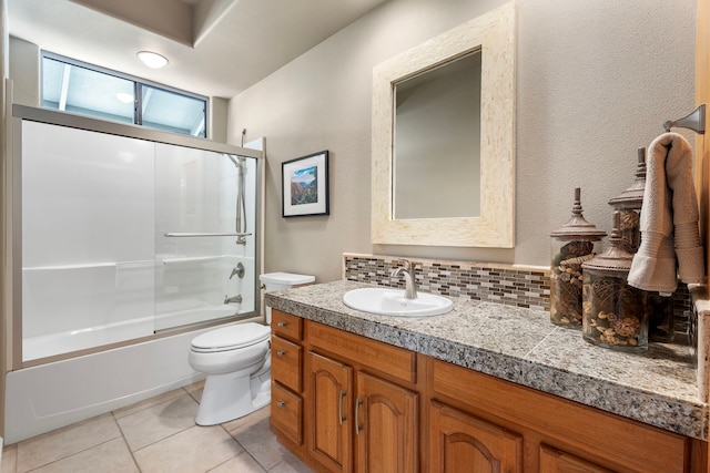 full bathroom with bath / shower combo with glass door, tasteful backsplash, vanity, tile patterned floors, and toilet