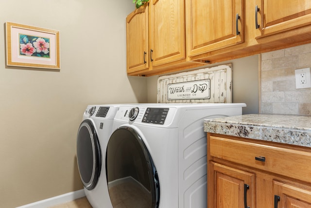 washroom featuring separate washer and dryer and cabinets