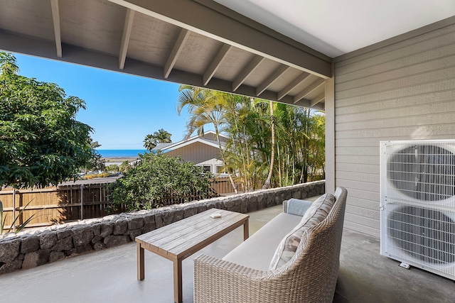 view of patio / terrace featuring ac unit, an outdoor hangout area, and a water view