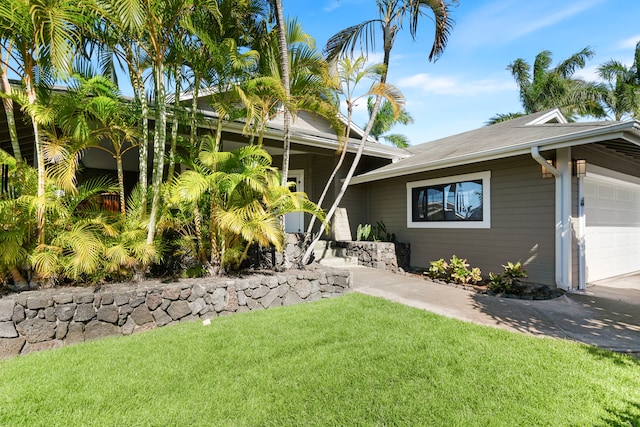 view of front of property with a garage and a front yard