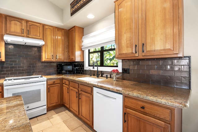 kitchen with sink, white appliances, light stone countertops, and light tile patterned floors