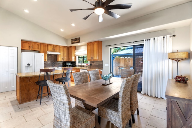 dining area with vaulted ceiling, light tile patterned floors, and ceiling fan