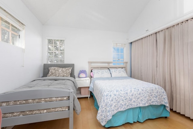 bedroom with lofted ceiling and hardwood / wood-style floors