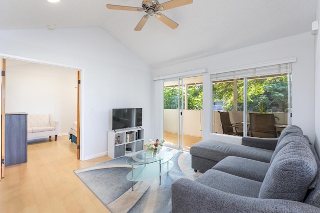 living room featuring lofted ceiling, ceiling fan, and light hardwood / wood-style flooring