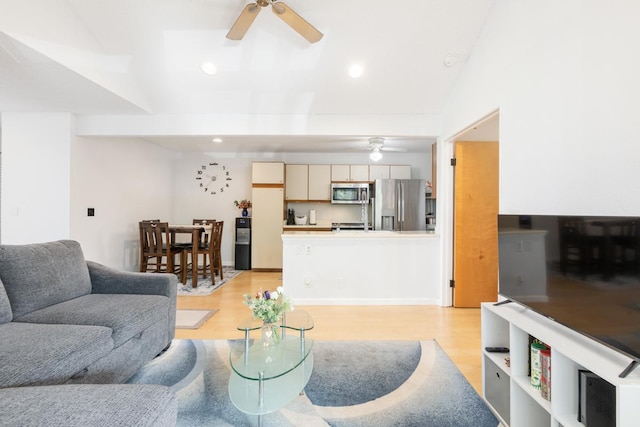 living room with ceiling fan and light wood-type flooring