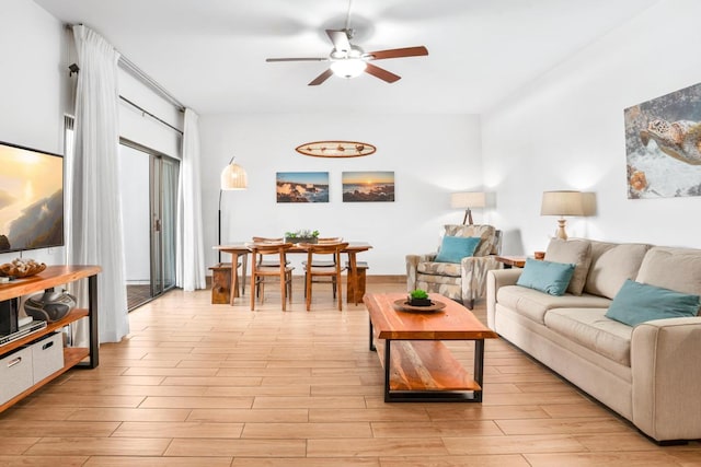 living room featuring light wood-type flooring and ceiling fan