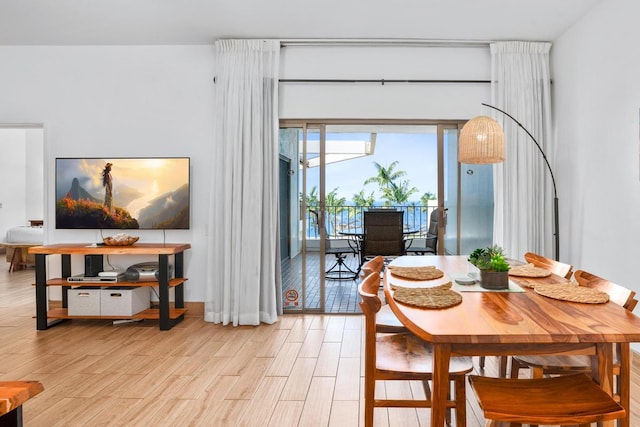 dining space featuring light wood finished floors