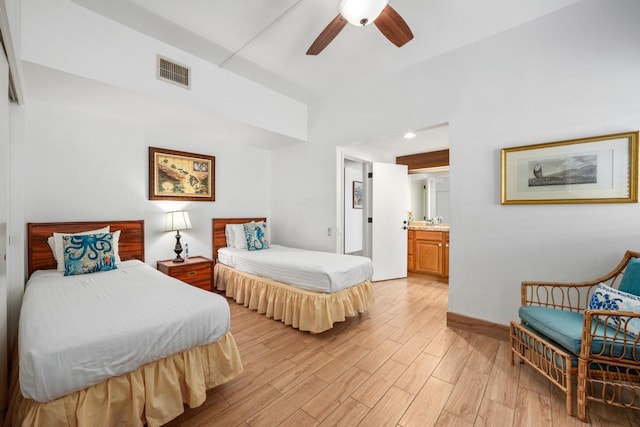 bedroom featuring visible vents, light wood-style floors, connected bathroom, ceiling fan, and baseboards