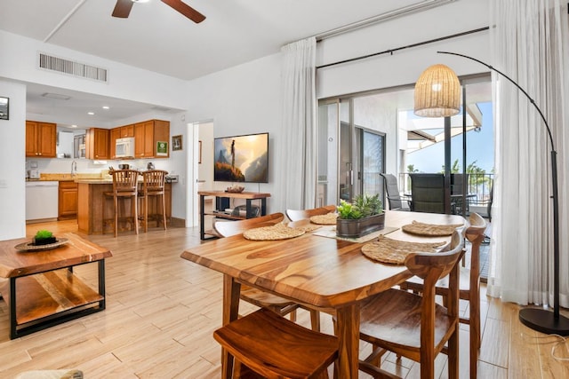 dining area featuring ceiling fan, visible vents, and light wood-style floors