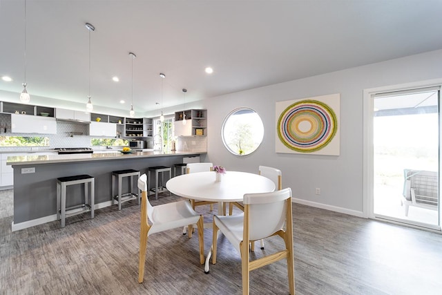 dining room with recessed lighting, baseboards, and wood finished floors